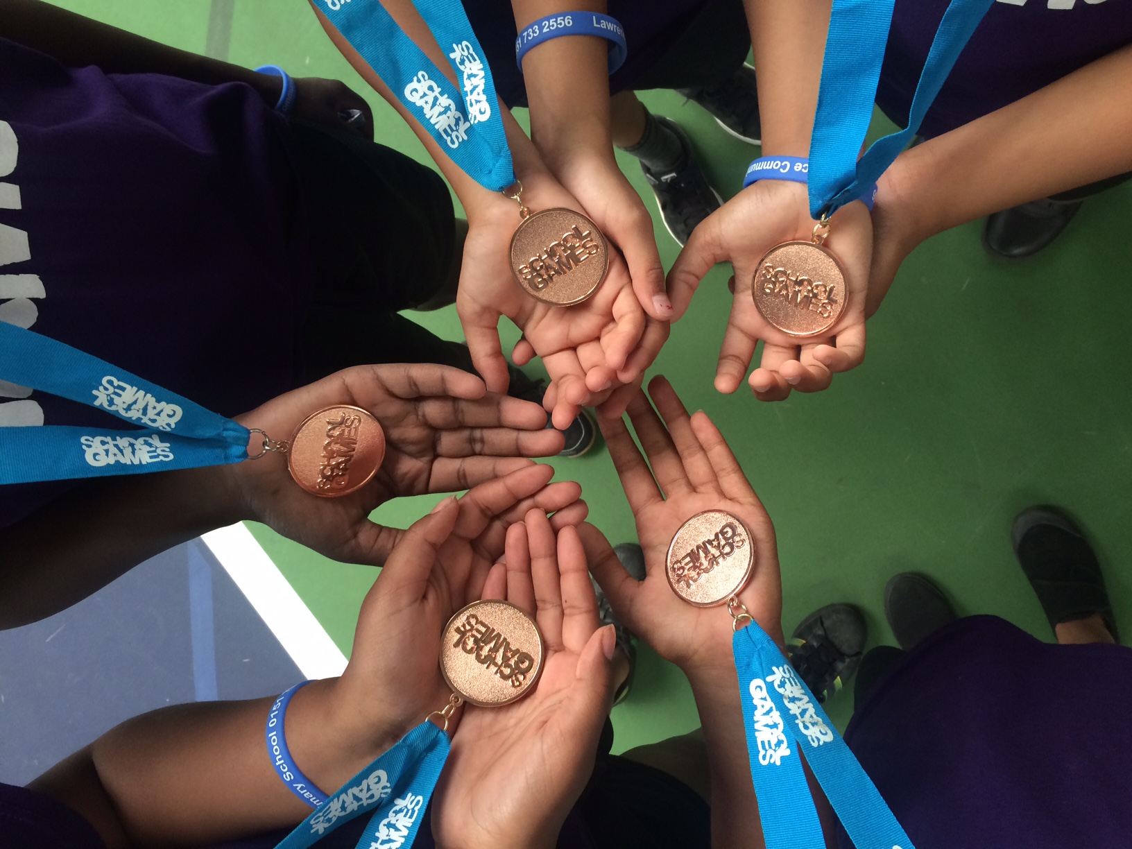 MSP School Games participants hold medals in their hands MSP